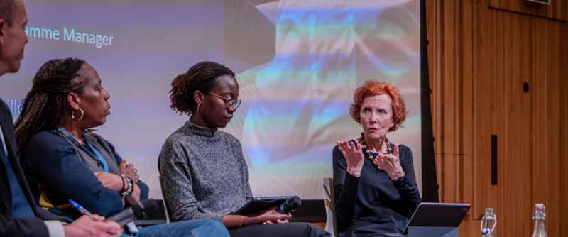 4 panellists sit on a stage in discussion 