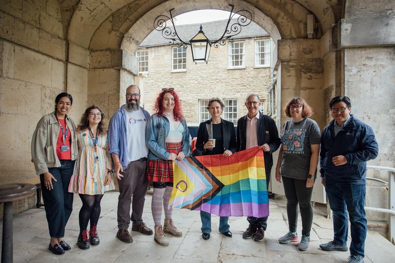 Members of the LGBTQ+ Task and Finish Group woith VC Irene Tracey holding a progress flag in the cloisters at Worcester College for Oxford Pride breakfast 2025